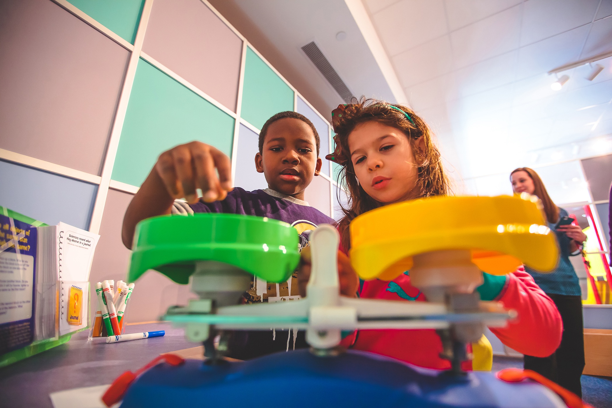 In the "Sid the Science Kid" exhibit, visitors can take measurements and weights then record their observations.