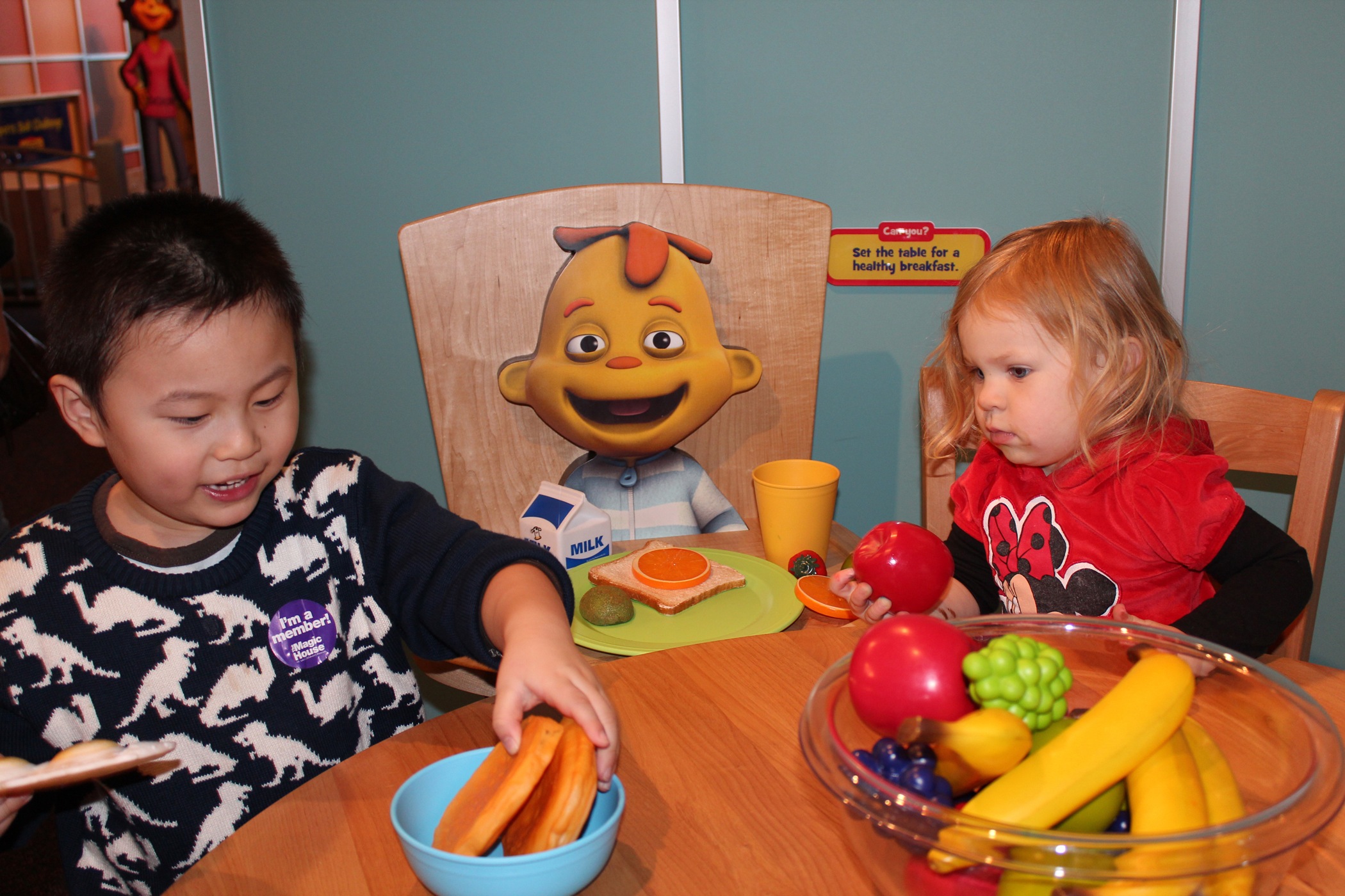Kids can sit down at the kitchen table with Sid's little brother, Zeke.