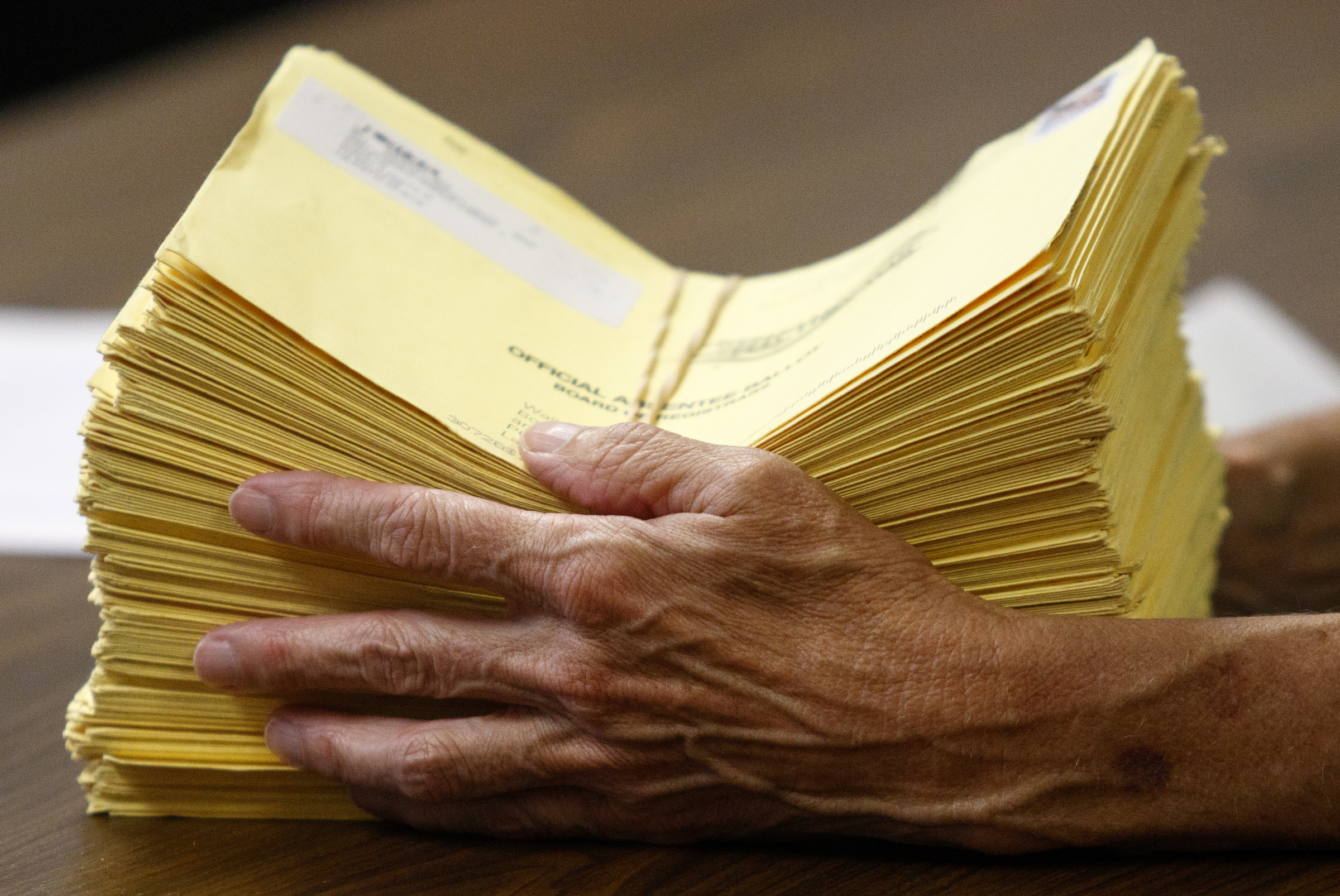 An elections official holds counted absentee ballots on primary election night at the Walker County Courthouse Tuesday, May 24, 2016, in Lafayette, Ga. GOP primary candidate Shannon Whitfield beat opponent Mike Peardon for his party's nomination and will face incumbent and former GOP member Bebe Heiskell in the fall for Walker County's sole commissioner's seat.