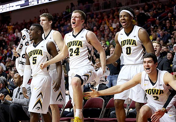Iowa guard Anthony Clemmons, guard Brady Ellingson, forward Ahmad Wagner and guard Andrew Fleming celebrate a 3-point basketball during the second half of an NCAA college basketball game against Drake, Saturday, Dec. 19, 2015, in Des Moines, Iowa. (AP Photo/Justin Hayworth)