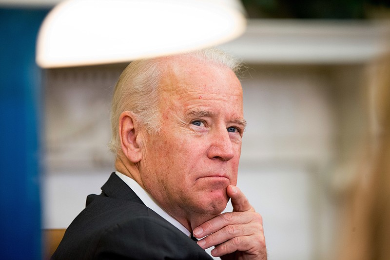 
              In this May 20, 2016, file photo, Vice President Joe Biden listens as President Barack Obama speaks to members of the media in the Oval Office at the White House in Washington Biden will bring together scientists, oncologists, donors and patients for a national conference on cancer research in Washington, the White House said May 24. Dubbed the “National Cancer Moonshot Summit,” the summit is scheduled for June 29 at Howard University, and the White House said it planned to organize dozens regional summits on the same day in communities far from the capital.  (AP Photo/Andrew Harnik)
            