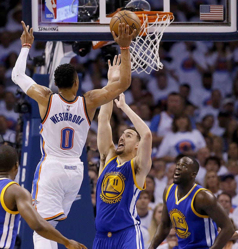
              Oklahoma City Thunder guard Russell Westbrook (0) shoots over Golden State Warriors guard Klay Thompson (11) during the first half in Game 4 of the NBA basketball Western Conference finals in Oklahoma City, Tuesday, May 24, 2016. Warriors forward Draymond Green (23) looks on. (AP Photo/Sue Ogrocki)
            