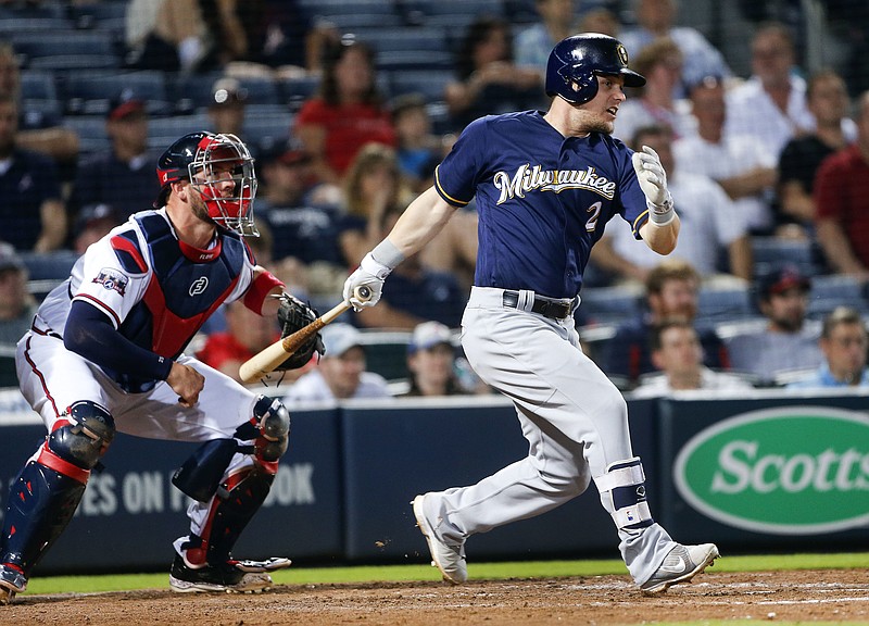 Milwaukee Brewers' Scooter Gennett (2) drives in the game-winning run with a base hit as Atlanta Braves catcher Tyler Flowers (25) looks on in the eighth inning of baseball game Tuesday, May 24, 2016, in Atlanta.