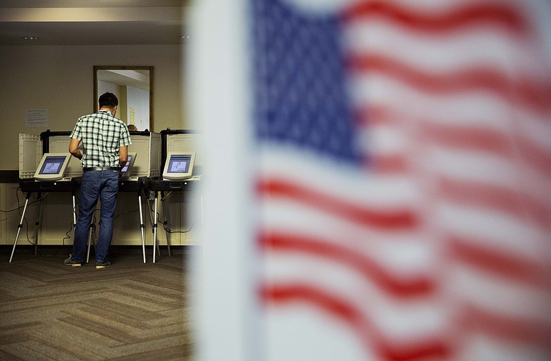 A voter casts a ballot at a polling site Tuesday, May 24, 2016, in Atlanta.