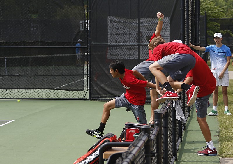 Staff Photo by Dan Henry / The Chattanooga Times Free Press- 5/25/16. Baylor's boys tennis team jump the fence to celebrate as Cooper Long wins the match securing the team's state championship title over Memphis University School during the TSSAA Division II Class AA Boys' State Tennis Championships final in Murfreesboro, TN., on May 25, 2016. 