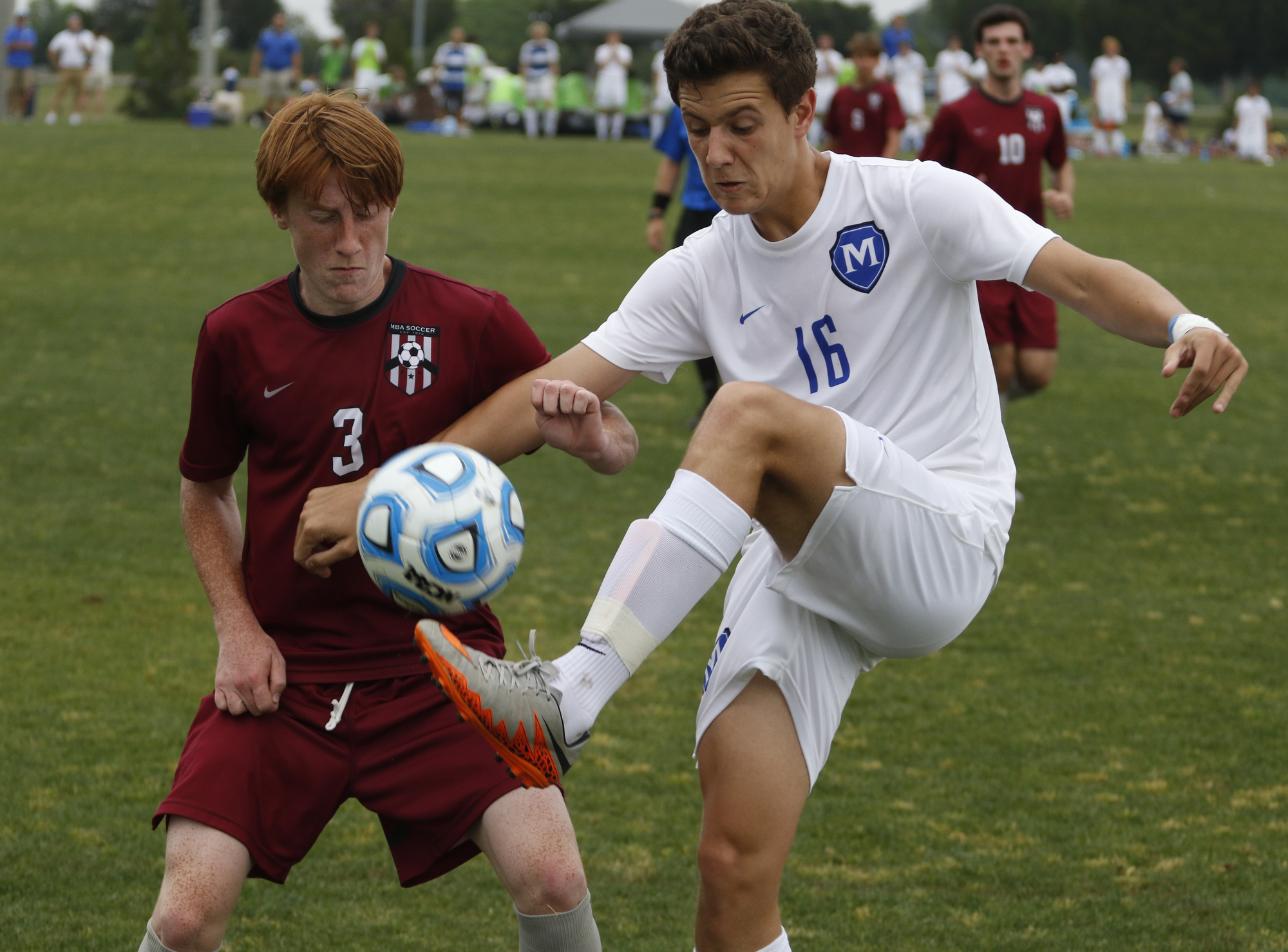 Staff Photo by Dan Henry / The Chattanooga Times Free Press- 5/25/16. McCallie School's Cameron Bett (16) fights Montgomery Bell Academy's Ellis Moore (3) for possession of the ball during the 2016 TSSAA Division II State Soccer Championship Match at the Richard Siegel Soccer Complex in Murfreesboro, TN., on May 25, 2016. McCallie lost 0-1.