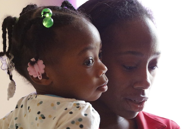 Two-year-old Zoey Duncan hugs her mother Bianca Horton while at their apartment on Jan. 7, 2016.
