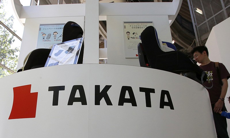 
              FILE - In this May 4, 2016 file photo, visitors look at child seats, manufactured and displayed by Takata Corp. at an automaker's showroom in Tokyo.  Money-losing Japanese air bag maker Takata Corp. hired financial advisory and asset management firm Lazard Thursday, May 26 to help tackle financial problems and massive recalls. (AP Photo/Shizuo Kambayashi, File)
            