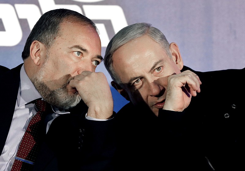 
              FILE - In this Wednesday, Jan. 16, 2013 file photo, Prime Minister Benjamin Netanyahu, right, and former Foreign Minister Avigdor Lieberman speak during a Likud-Yisrael Beitenu campaign rally in the port city of Ashdod. Israeli officials say a deal has been reached to expand the coalition government by bringing in the ultranationalist Yisrael Beitenu party of Avigdor Lieberman. (AP Photo/Tsafrir Abayov, File)
            
