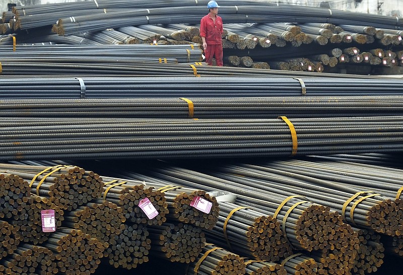 
              In this April 25, 2016 photo, a man works in a steel market in Yichang in central China's Hubei province. China accused the United States on Thursday, May 26, 2016 of hampering trade after Washington imposed duties of up to 450 percent on Chinese steel in its latest response to a flood of low-priced imports. (Chinatopix via AP) CHINA OUT
            