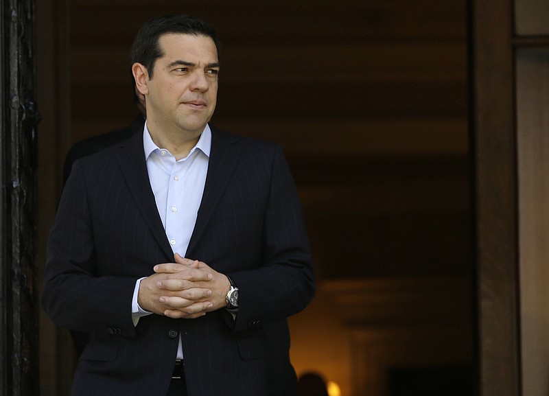 
              Greece's Prime Minister Alexis Tsirpas waits for the arrival of the Cypriot President Nicos Anastasiades at the Maximos Mansion in Athens, Wednesday, May 25, 2016. Greece has won an essential batch of bailout funds from international creditors following agreement among the 19 eurozone finance ministers and can start looking forward to debt relief in the future. (AP Photo/Thanassis Stavrakis)
            
