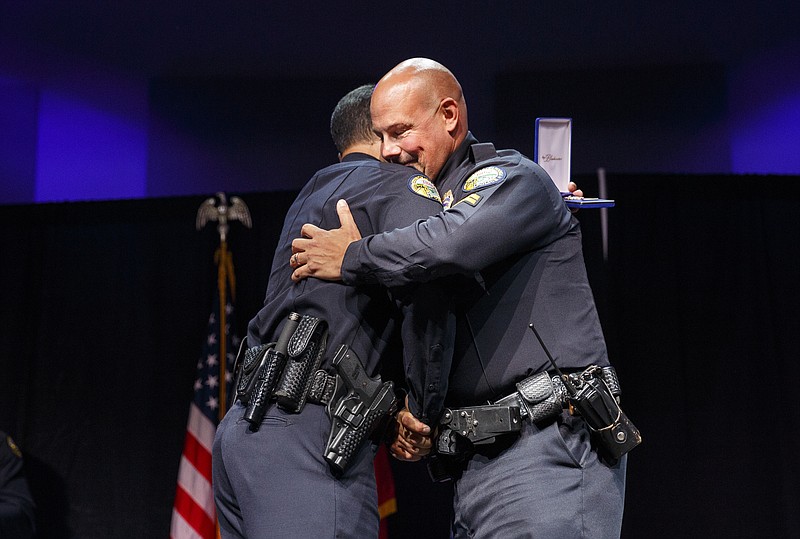 Chief Fred Fletcher, left, awards Officer Dennis Pedigo a purple heart during the Chattanooga Police Department's annual awards ceremony held at Calvary Chapel on Thursday, May 26, 2016, in Chattanooga, Tenn. Pedigo was awarded the medal after he was shot responding to the July 16, 2015, shootings at area military facilities.
