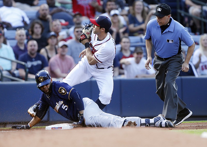 Milwaukee Brewers' Jonathan Villar (5) is tagged out at third base by Atlanta Braves third baseman Chase d'Arnaud as he tried to stretch a double during the third inning of a baseball game Wednesday, May 25, 2016, in Atlanta. (AP Photo/John Bazemore)