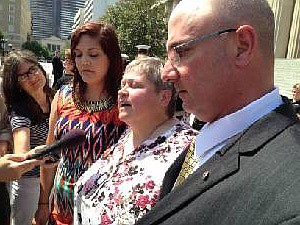 Cathy Wells, center, mother of Marine Lance Cpl. Skip Wells who was killed in 2015 Chattanooga attack, speaks to reporters following Tennessee ceremony. At left is Jasmine Holmquist, widow of Marine Sgt. Carson Holmquist, and Tracy Smith, father of Petty Officer Randall Smith, also killed in the terrorist-inspired attack.