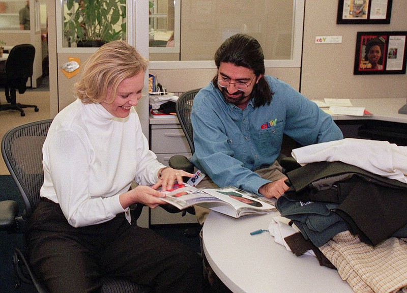 
              File - In this May 21, 1999 file photo, eBay chief executive officer Meg Whitman, left, and Pierre Omidyar, eBay's chairman of the board, leaf through a magazine at the company's headquarters in San Jose, Calif. The courtroom fight between former pro wrestler Hulk Hogan and news-and-gossip site Gawker is becoming a battleground for Silicon Valley tycoons as well. First Look Media, a news organization financed by Omidyar, philanthropist and the co-founder of eBay, is reaching out to other media outlets to file supportive briefs about Gawker, according to the New York Post. The briefs could be used for the site’s appeal of a $140 million invasion-of-privacy verdict Hogan won two months ago because Gawker posted a sex tape of him. (AP Photo/Randi Lynn Beach, File)
            