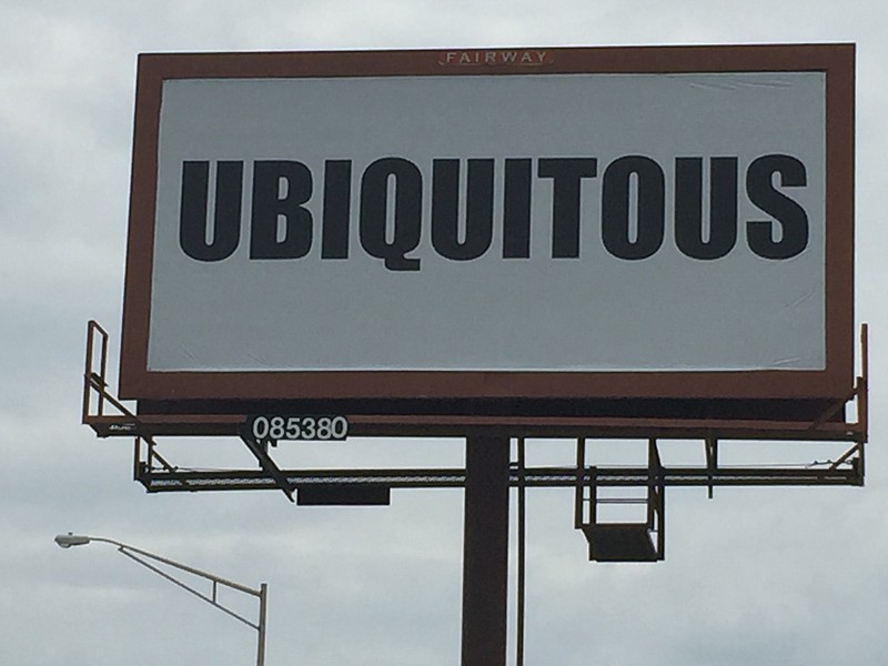 The story was revealed Friday for those black-and-white billboards with the single word "Ubiquitous" on them that popped up all over the Chattanooga area. Coca-Cola will use the 60 billboards to promote its "Share a Coke and a Song" summer advertising campaign.