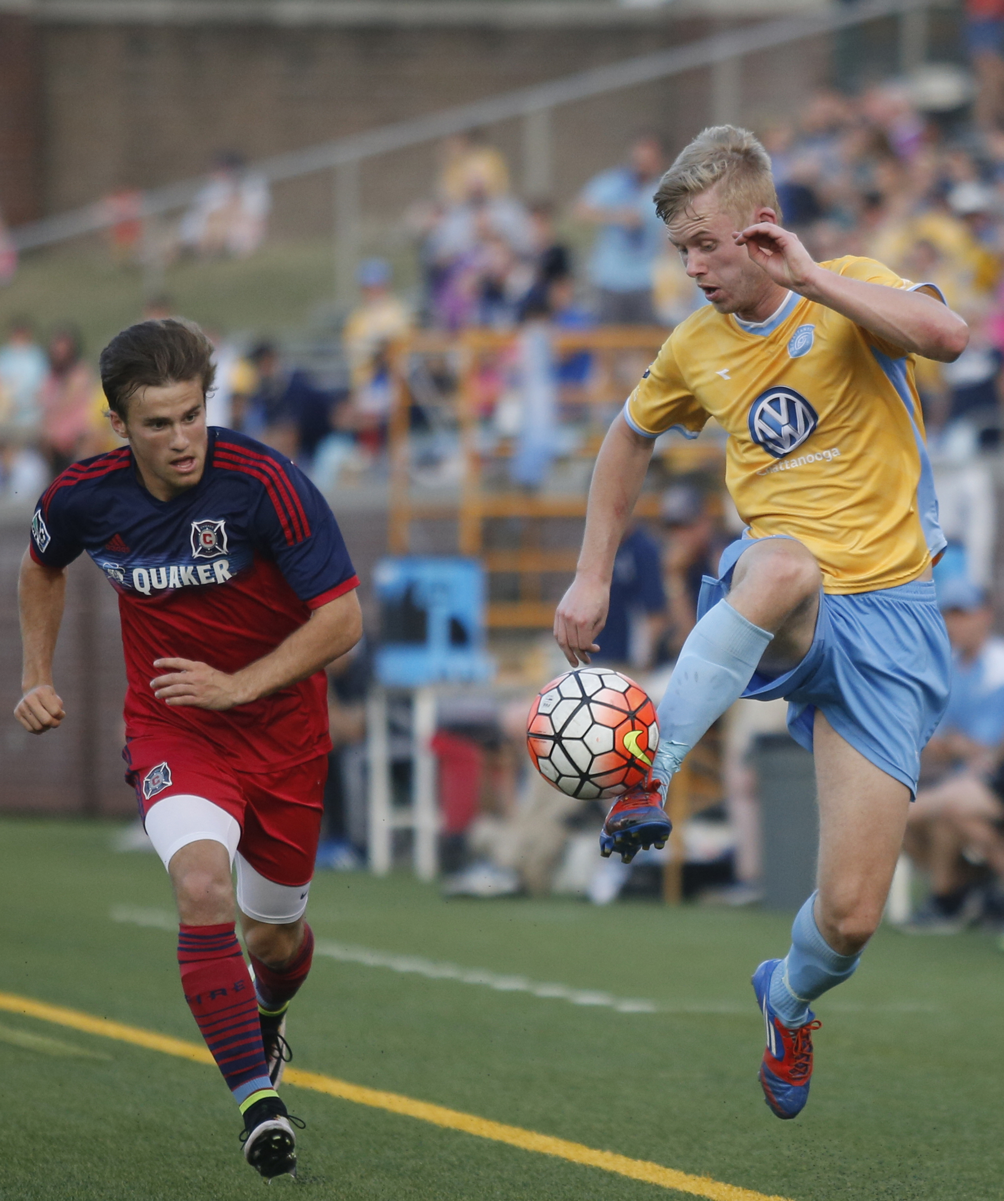 CFC's Sindre Welo, right, leads the ball down the sideline ahead of Chicago's Brody Kraussel during Chattanooga FC's Hank Steinbrecher Cup championship match against the Chicago Fire at Finley Stadium on Saturday, May 28, 2016, in Chattanooga, Tenn.