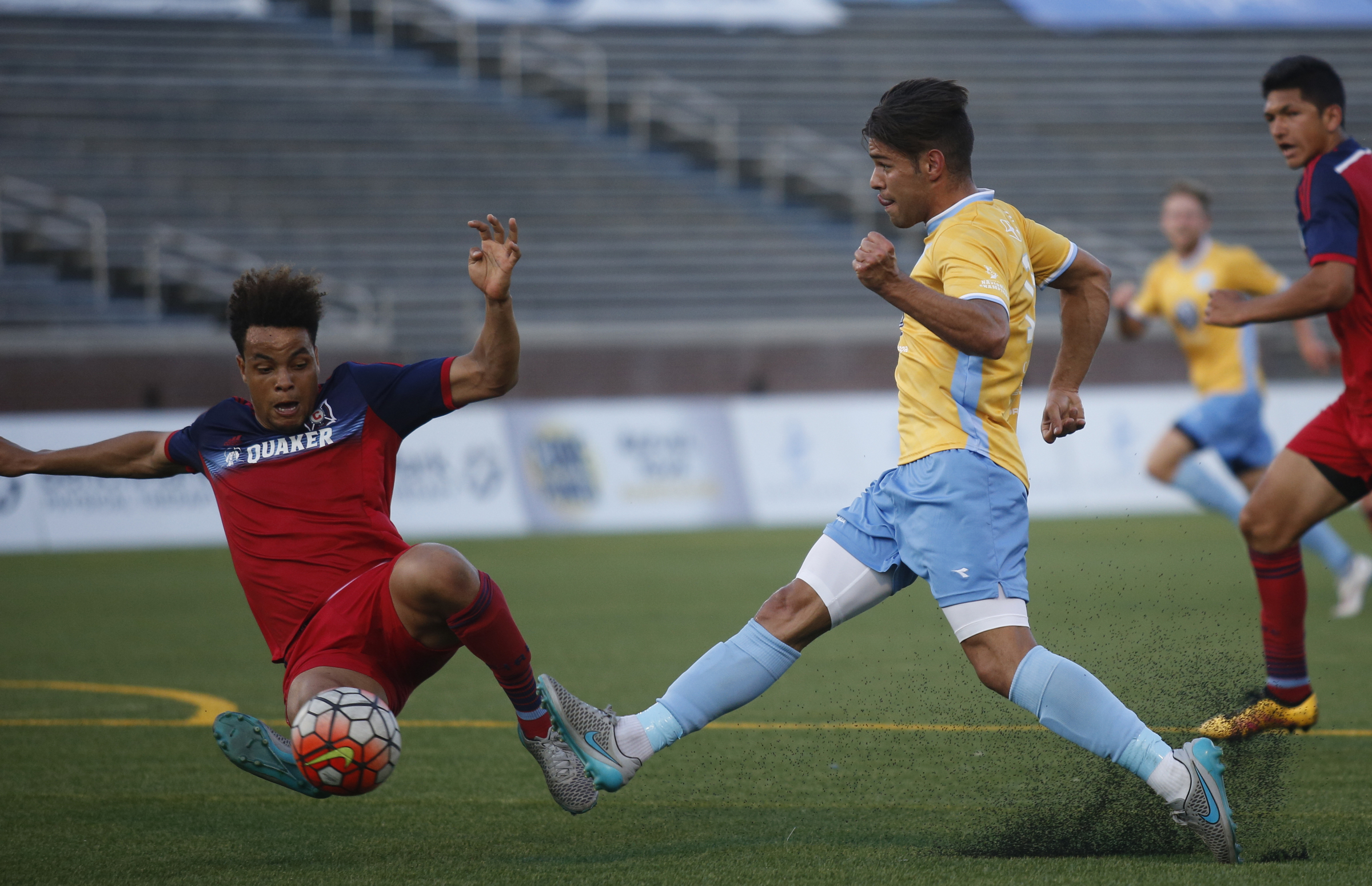Chicago's Abdou Samake clears a shot by CFC's Samuel Goni, right, during Chattanooga FC's Hank Steinbrecher Cup championship match against the Chicago Fire at Finley Stadium on Saturday, May 28, 2016, in Chattanooga, Tenn.