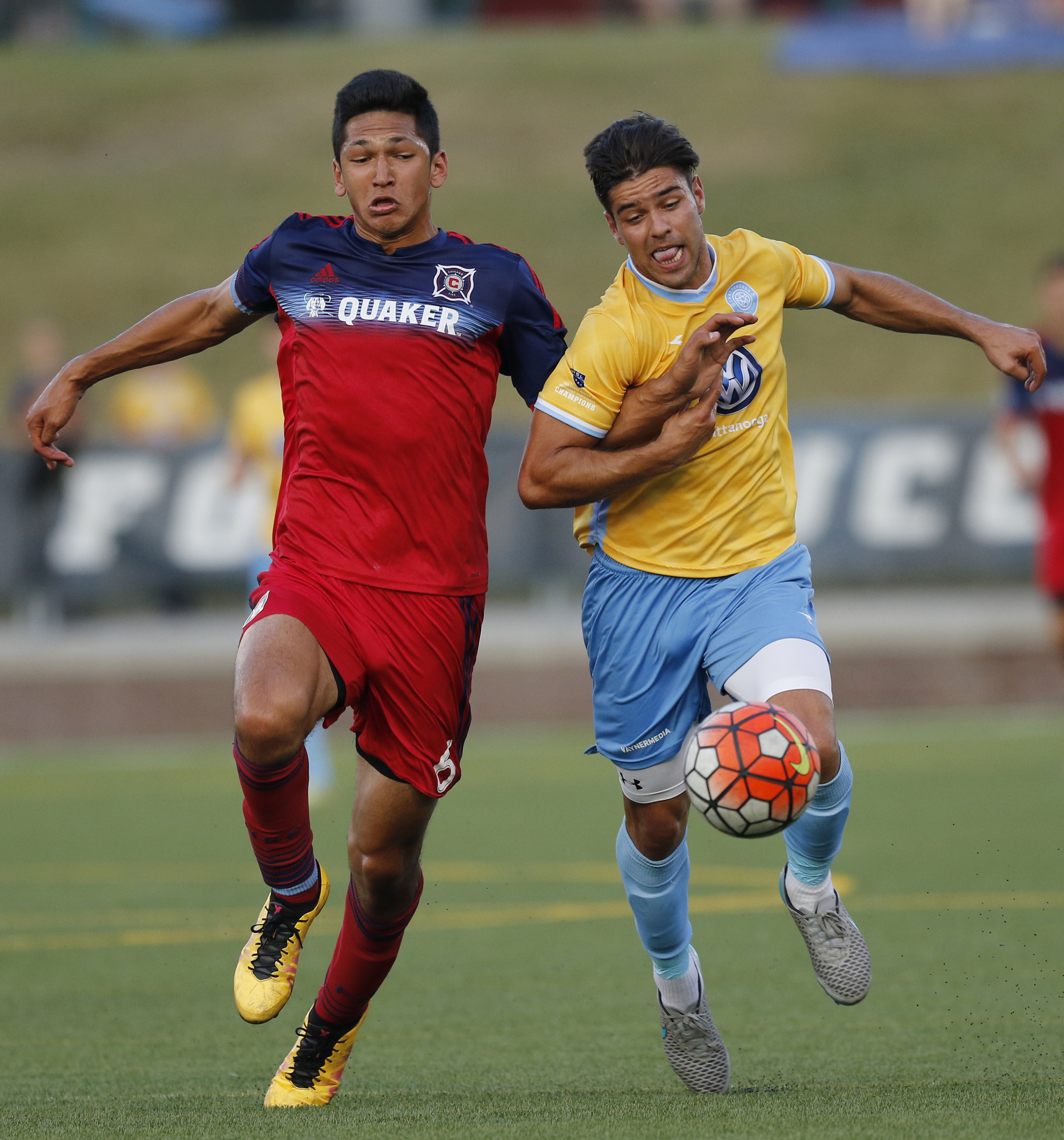 CFC's Samuel Goni, right, and Chicago's Mauricio Pineda fight to control a long ball during Chattanooga FC's Hank Steinbrecher Cup championship match against the Chicago Fire at Finley Stadium on Saturday, May 28, 2016, in Chattanooga, Tenn.