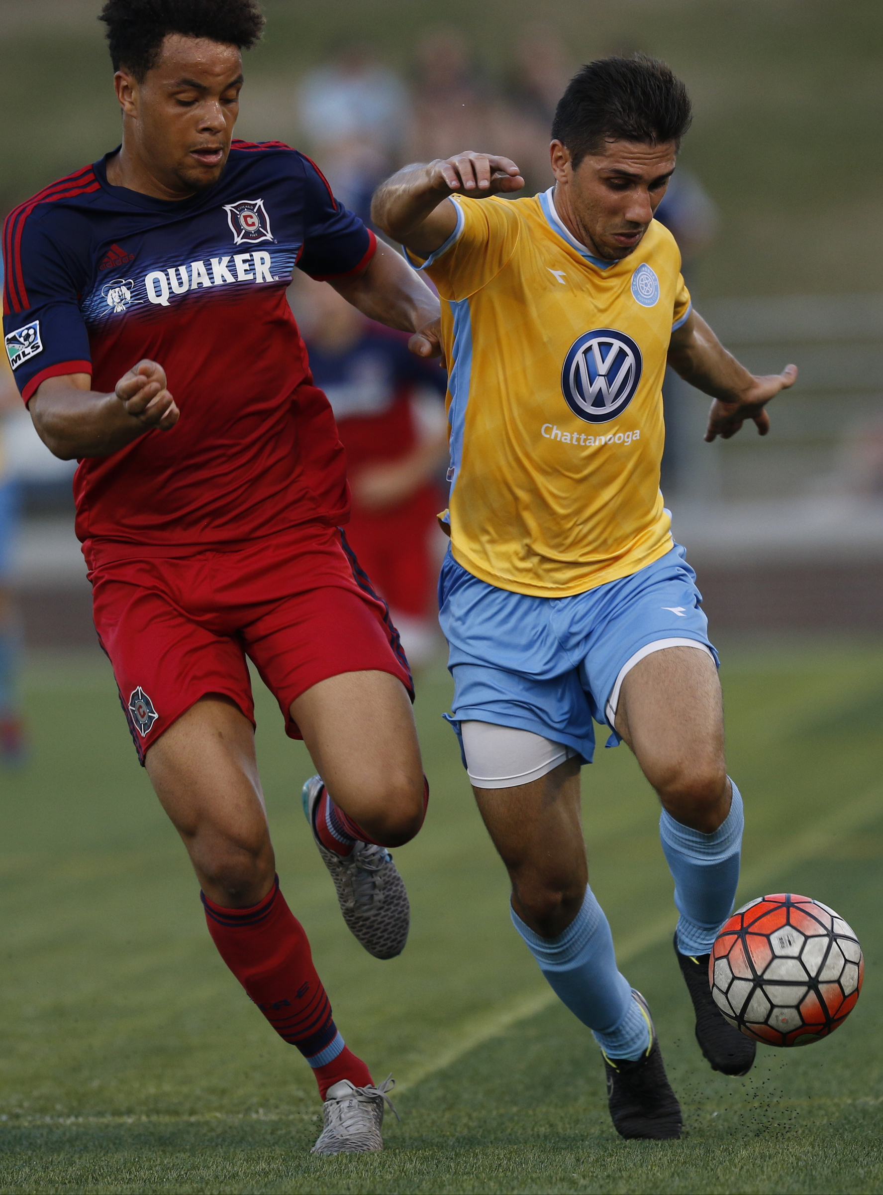 CFC's Luis Trude, right, tries to break around Chicago's Abdou Samake during Chattanooga FC's Hank Steinbrecher Cup championship match against the Chicago Fire at Finley Stadium on Saturday, May 28, 2016, in Chattanooga, Tenn.