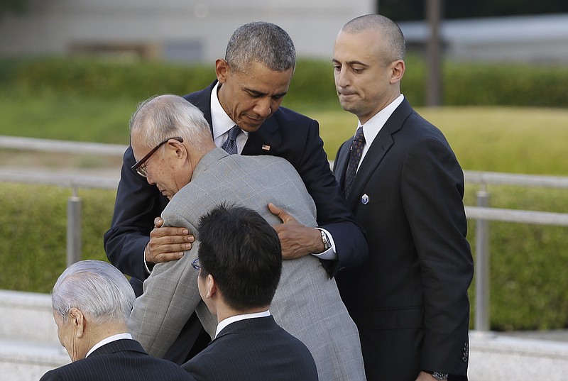 
              U.S. President Barack Obama hugs Shigeaki Mori, an atomic bomb survivor and a creator of the memorial for American WWII POWs killed in Hiroshima, during a ceremony at Hiroshima Peace Memorial Park in Hiroshima, western, Japan, Friday, May 27, 2016. Obama on Friday became the first sitting U.S. president to visit the site of the world's first atomic bomb attack, bringing global attention both to survivors and to his unfulfilled vision of a world without nuclear weapons. (AP Photo/Carolyn Kaster)
            