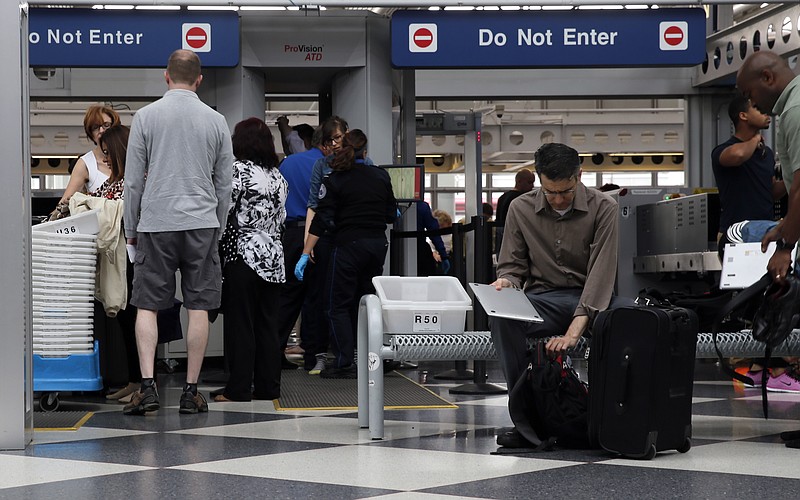 
              Travelers pass through a Transportation Security Administration checkpoint at O'Hare International Airport, Friday, May 27, 2016, in Chicago. Memorial Day weekend, the unofficial start of summer vacations for many and a busy travel period, serves as a crucial test for the TSA. (AP Photo/Kiichiro Sato)
            