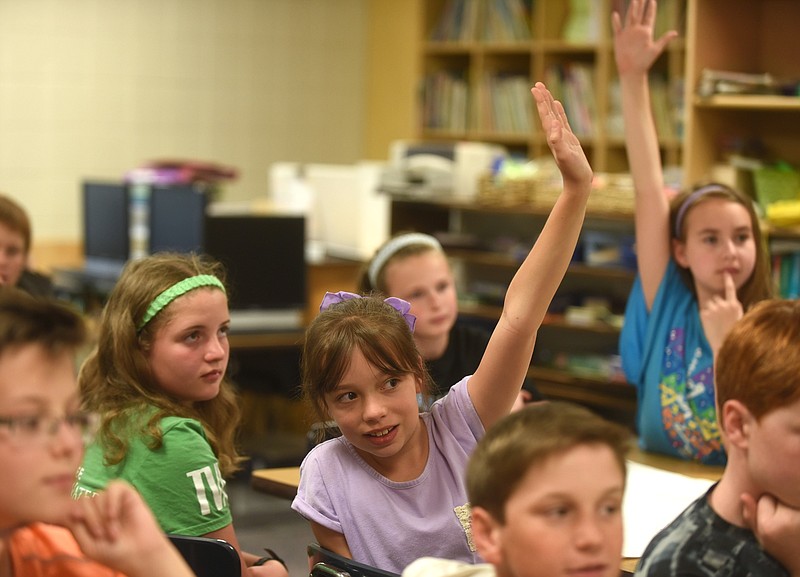 Tess Pope, center, raises her hand May 24, 2016 in her Nolan Elementary classroom about TNReady project that they researched and sent to Governor Bill Haslam.
