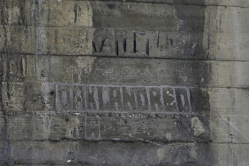 
              In this Monday, May 16, 2016 photo, some graffiti left by hobos are seen under the bridge in Los Angeles. The writings and drawings, some dating to 1914, were written with utensils like grease pencils or etched into the concrete under a 103-year-old bridge spanning the Los Angeles River. (AP Photo/Jae C. Hong)
            