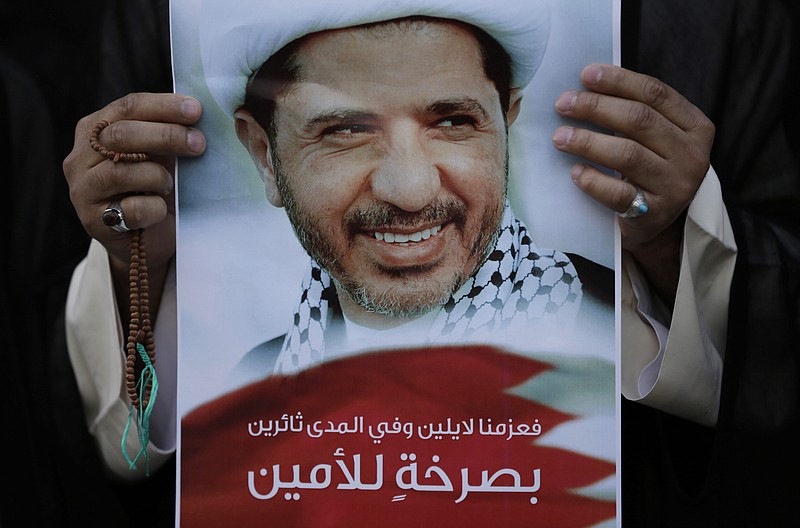 
              FILE - In this Wednesday, Feb. 25, 2015 file photo, a Bahraini anti-government protester holds up an image of jailed Shiite opposition leader Sheikh Ali Salman demanding his freedom during a protest in Daih, Bahrain.  A Bahraini appeals court has more than doubled the prison term for the country's top Shiite opposition figure who was part of the island nation's 2011 Arab Spring-inspired uprising (AP Photo/Hasan Jamali, File)
            