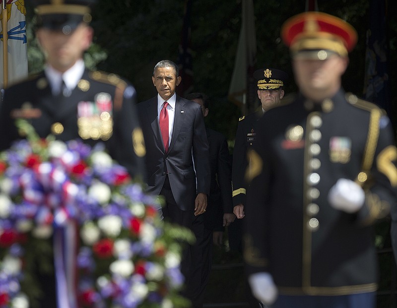 
              President Barack Obama, center, arrives with Maj. Gen. Bradley A. Becker, right, for the wreath laying ceremony at the Tomb of the Unknowns, on Memorial Day, Monday, May 30, 2016, at Arlington National Cemetery in Arlington, Va. (AP Photo/Pablo Martinez Monsivais)
            