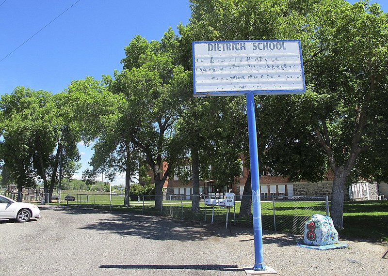
              In this Thursday, May 26, 2016 photo, an empty school reader board stands in front of the only school building in Dietrich, Idaho. The small community is struggling with the national attention brought by reports that a disabled black football player was raped by his white high school teammates. The allegations of racist taunts and physical abuse suffered by the teen were revealed this month when the family filed a $10 million lawsuit against the Dietrich School District.  (AP Photo/Kimberlee Kruesi)
            