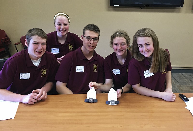 
              In this April 23, 2016, photo, members of the Meeker County Ag Squad are seen at the University of Minnesota in St. Paul showing off the GPS ear tags they developed to help farmers track their livestock from far away. From left are: are Andrew Massmann, Jackie Massmann, Casey Gohmann, Abbey Schiefelbein, and Bailee Schiefelbein, all of Kimball, Minn. They're taking part in the 4-H Science of Agriculture Challenge, which aims to nurture the next generation of agricultural scientists for a country facing a critical shortage of them. (AP Photo/Steve Karnowski)
            