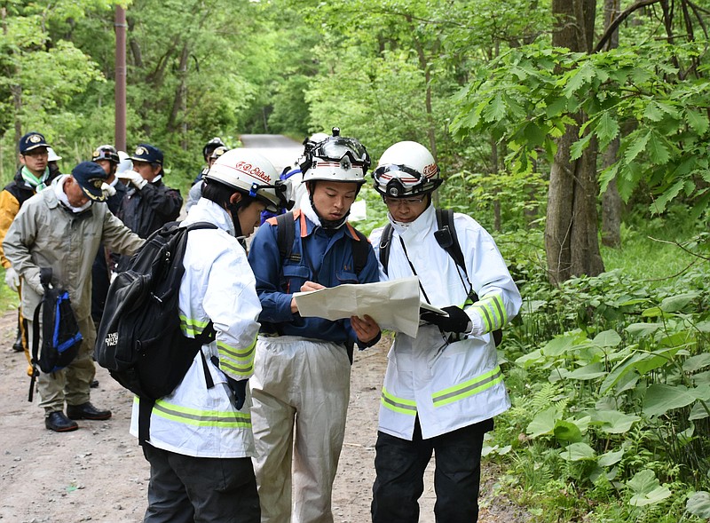 
              Rescuers search for a 7-year-old boy who is missing in a Japanese forest in Nanae town, on Hokkaido, the northernmost of Japan's four main islands Monday, May 30, 2016. He has been missing since late Saturday afternoon after his parents reportedly made him get out of the car as punishment. (Kyodo News via AP) JAPAN OUT, MANDATORY CREDIT
            