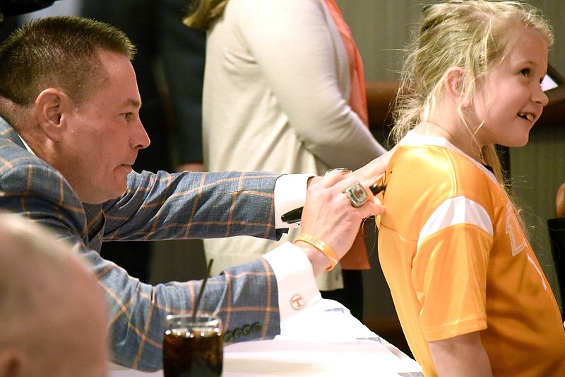 UT head football coach Butch Jones signs the back of Abigail Lambert's jersey. The University of Tennessee Big Orange Caravan rolled into town at the Chattanoogan on Thursday May 5, 2016.