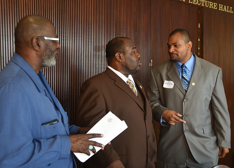 NAACP National Director of Criminal Justice, Carlton Mayers II, right, talks with Warbrit Lowery, left, and Eric Atkins Saturday at the NAACP 8th Annual Criminal Justice Seminar at the Chattanooga Choo Choo.