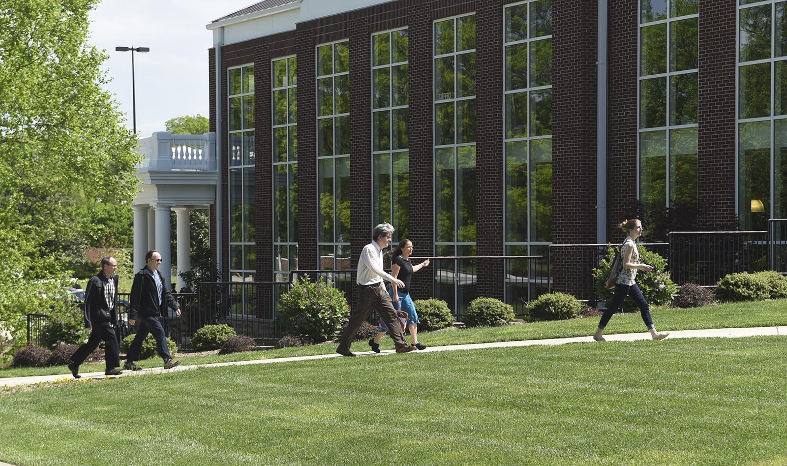 Southern Adventist University employees walk to a town meeting in the Iles Physical Education Center on Wednesday, Aug. 22, 2015, in Collegedale, Tenn. University President Gordon Bietz announced at the meeting that he will be stepping down in a year.