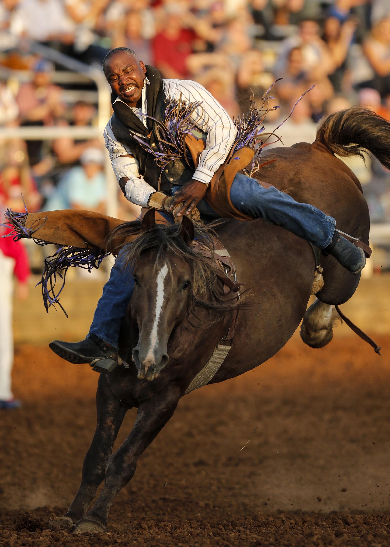 Jimmy Patterson rides a bronc in the Professional Cowboy Association's St. Jude's Children's Hospital Rodeo at Doug Yates Farm on Friday, Aug. 7, 2015, in Ringgold, Ga. The rodeo continues Saturday.