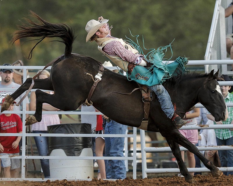 Shelton Murphy rides a bronc in the Professional Cowboy Association's St. Jude's Children's Hospital Rodeo at Doug Yates Farm on Friday, Aug. 7, 2015, in Ringgold, Ga. The rodeo continues Saturday.