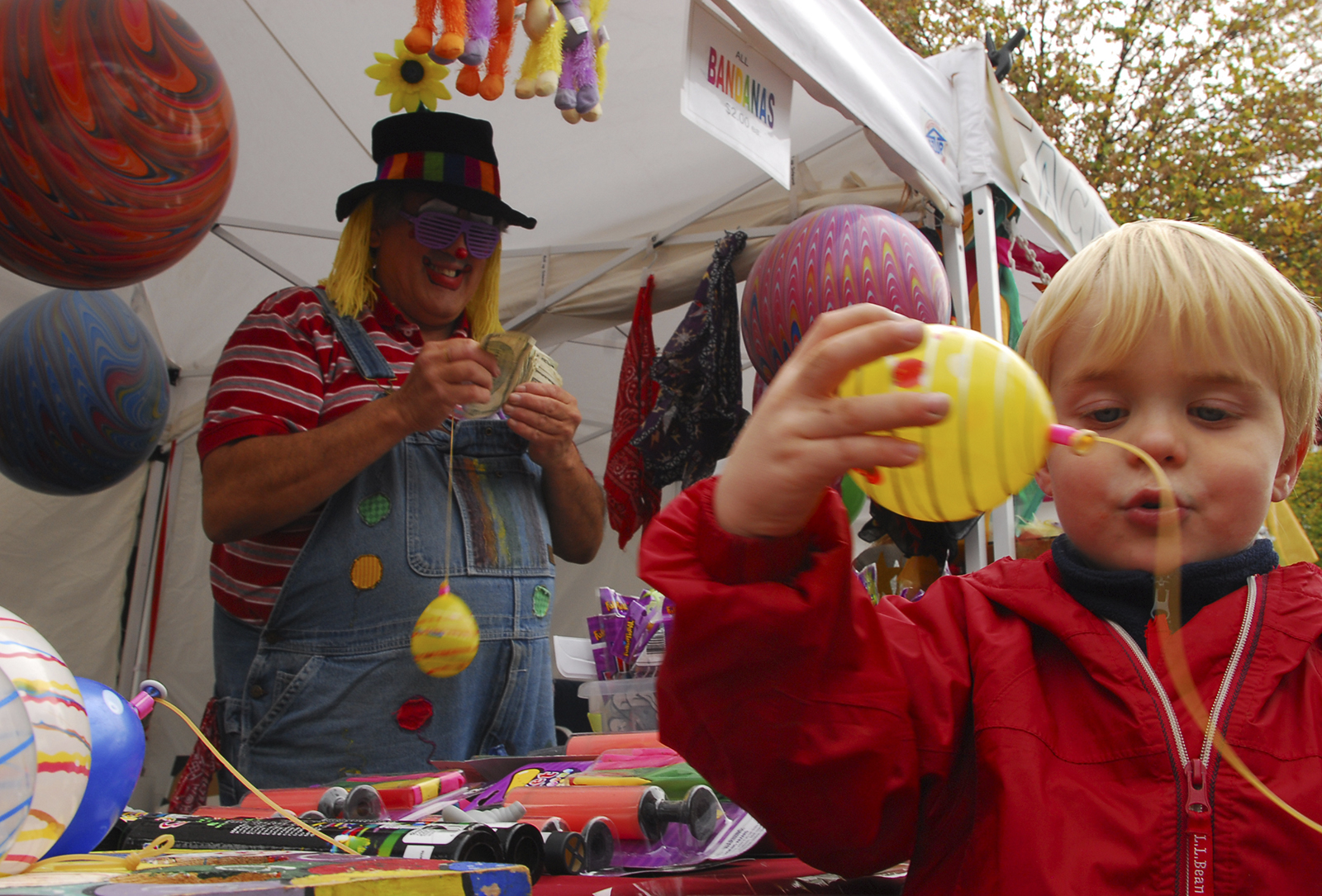 Redding Batt, 3, plays with a balloon toy at Cleveland's Apple Festival in downtown Cleveland on Saturday. Redding ended up deciding on a toy helicopter instead.