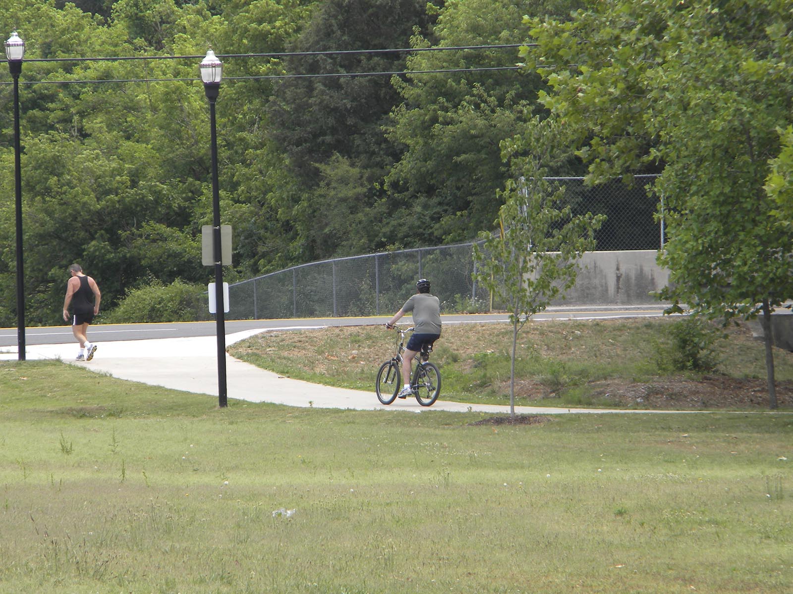 Cyclists, joggers and walkers usually turn around on the Cleveland/Bradley County Greenway when they reach Raider Drive. On Wednesday the Greenway Board held a groundbreaking ceremony to launch Phase Five of the greenway along Mouse Creek. Funded with a $569,000 grant from the Tennessee Department of Transportation, the new phase will connect the greenway from Raider Drive, in the background, north behind the Cleveland High School athletic fields to Tinsley Park and then connect to a pedestrian bridge dedicated in December, 2010. When the work is finished later this year, the greenway will be continuous for about four miles, from Willow Street north to Mohawk Drive.