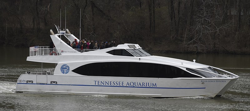 Passengers brave chilly temperatures to stand outside on the observation deck during a Valentine's Day cruise on the Tennessee Aquarium's River Gorge Explorer on Sunday, Feb. 14, 2016, in Chattanooga, Tenn.