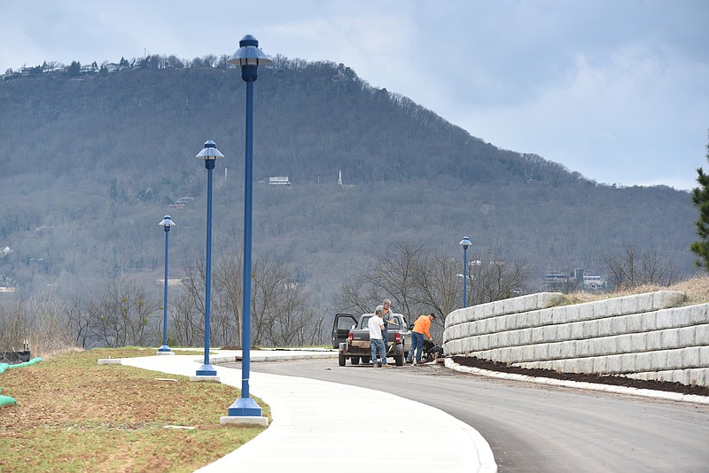 Thomas Brothers Construction, Inc. employee's Cecil Sanders, left, Daniel Smith and Jay Garner work to add mulch along the newest section of the Tennessee Riverwalk, just south of Siskin Steel.
