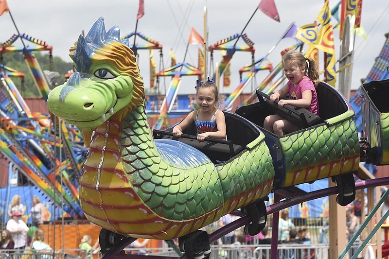 Children ride a roller coaster at the National Cornbread Festival on Sunday, Aug. 26,  2015, in South Pittsburg, Tenn. 