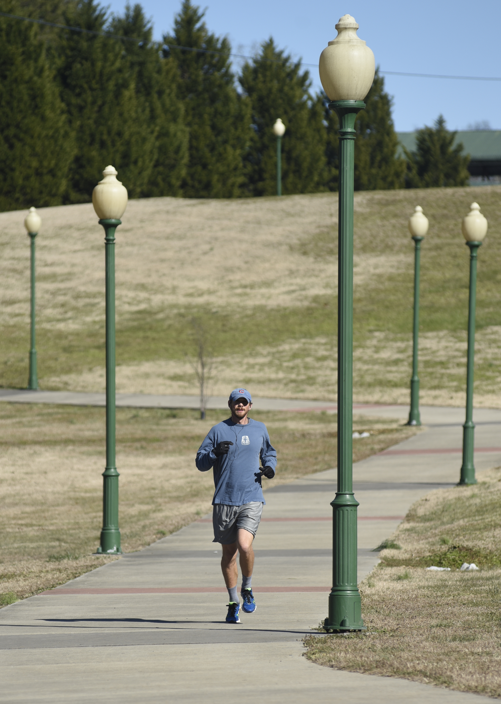 Taking advantage of sunshine and relative warmth, Troy Carlson runs on the Ronnie Moore Memorial Walkway in White Oak Park on Sunday, Jan. 24, 2016, in Red Bank, Tenn.