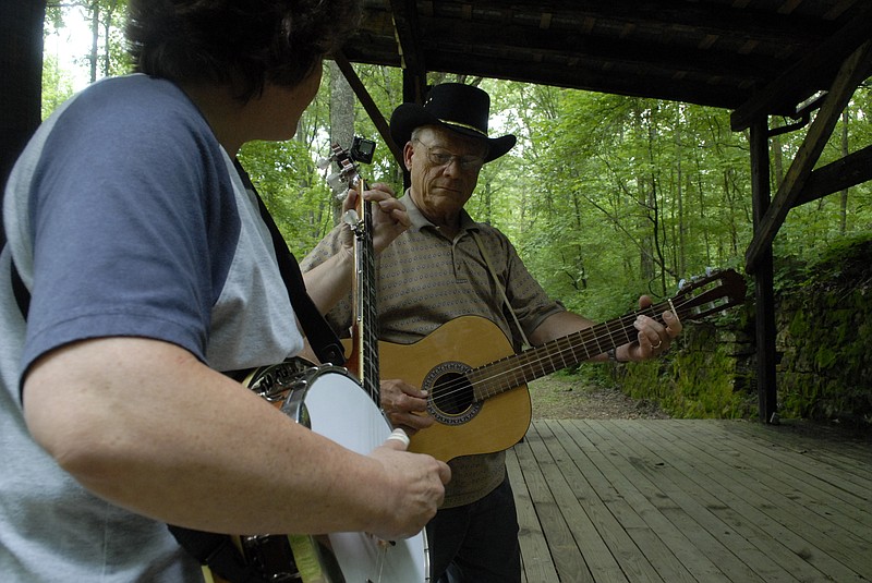 Ed Brown, on guitar, picks with Jill Hudson on banjo on the amphitheater stage at the Dunlap Coke Ovens Park in 2010. Brown is the lead vocalist and multi-instrumentalist for The Cumberland Band, who will perform multiple times this weekend during the 30th annual Coke Oven Bluegrass Festival.