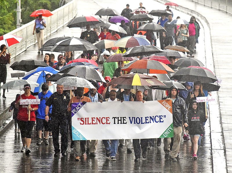 More than 100 people marched across the Walnut Street Bridge in wet conditions early last month to stand against the recent outbreak of violence in Chattanooga.