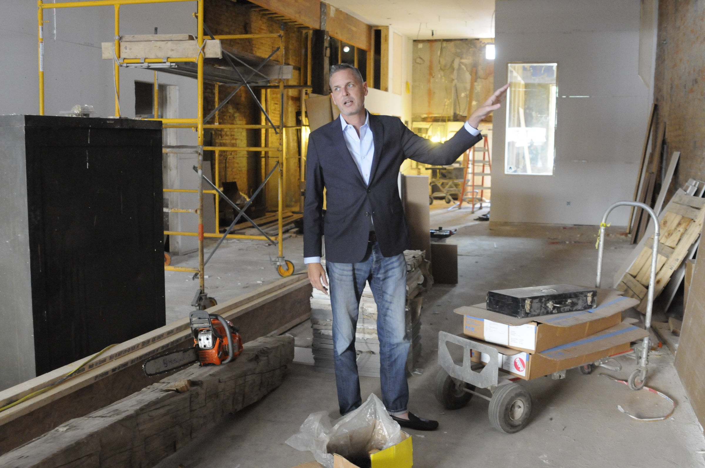 Christian Rushing talks about the new offices of his Chattanooga Design Studio amidst construction inside the former Cooper Office Supply on Cherry Street.