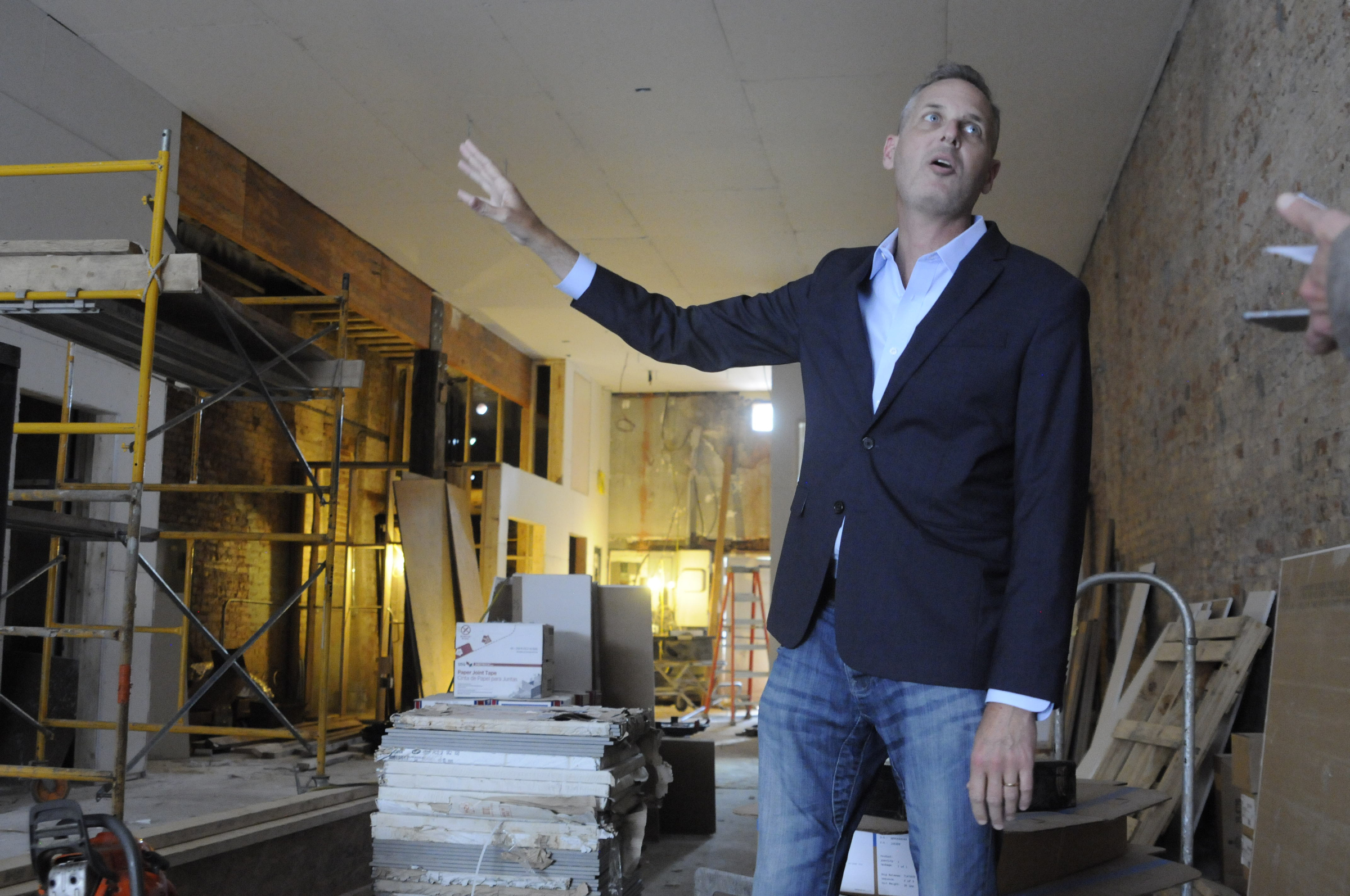 Christian Rushing talks about the new offices of his Chattanooga Design Studio amidst construction inside the former Cooper Office Supply on Cherry Street.