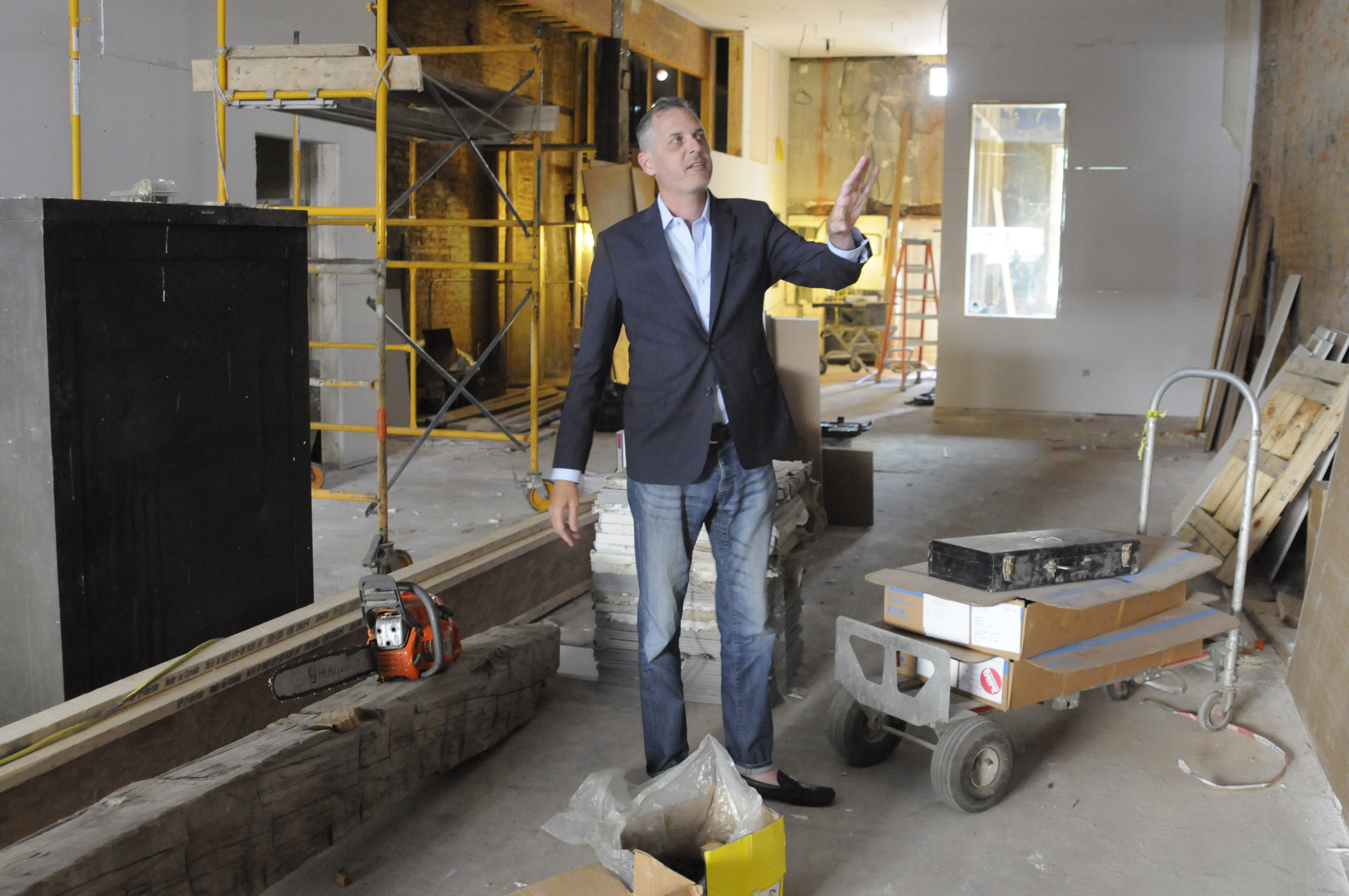 Christian Rushing talks about the new offices of his Chattanooga Design Studio amidst construction inside the former Cooper Office Supply on Cherry Street.