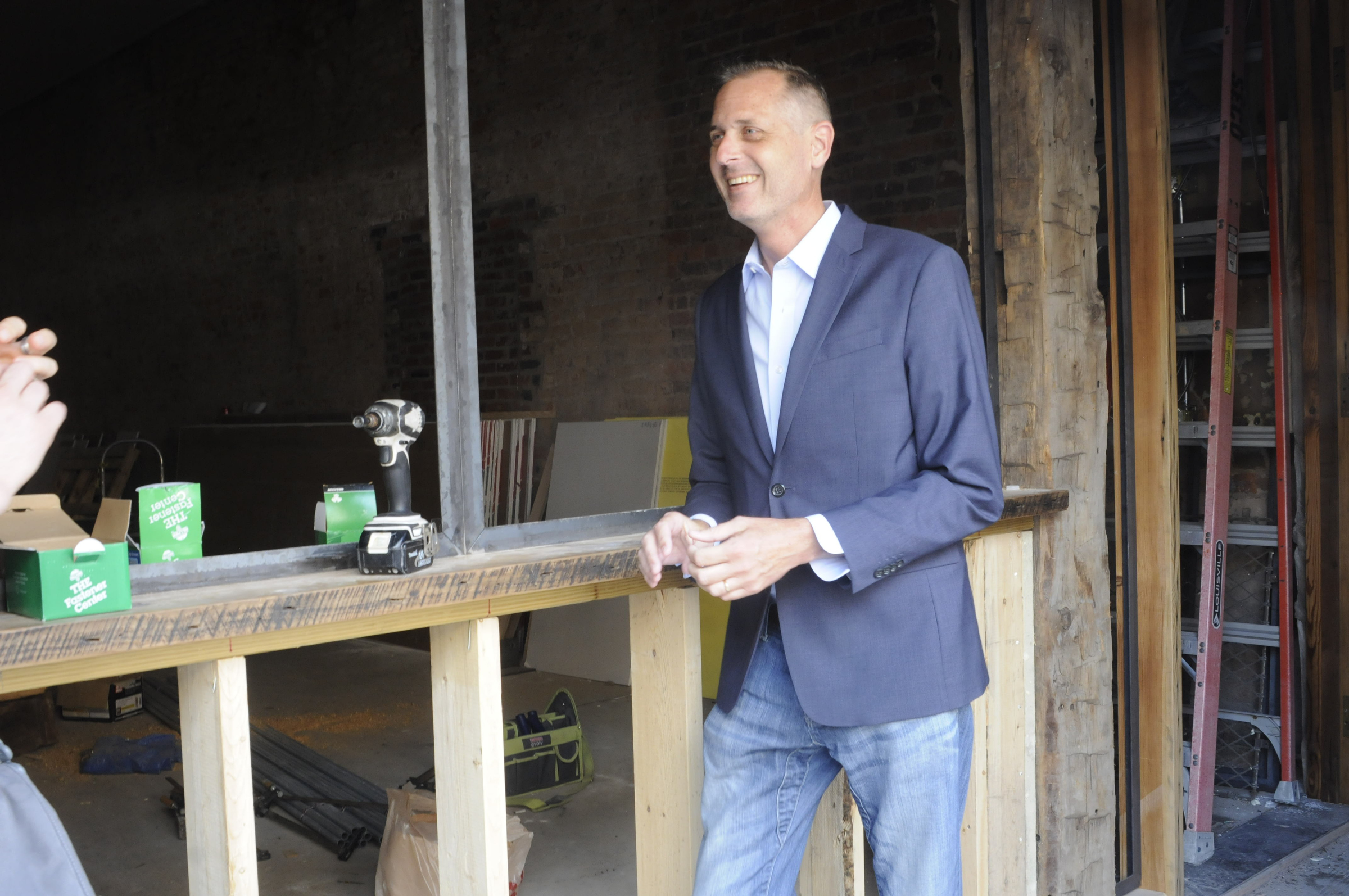Christian Rushing talks about the new offices of his Chattanooga Design Studio amidst construction inside the former Cooper Office Supply on Cherry Street.